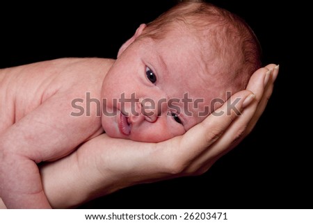 Newborn baby with its eyes wide open.