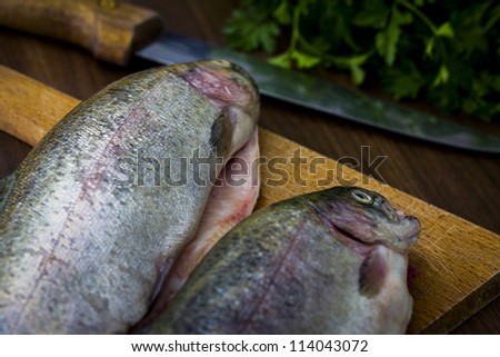 Two raw trouts on the kitchen table, ready to cook