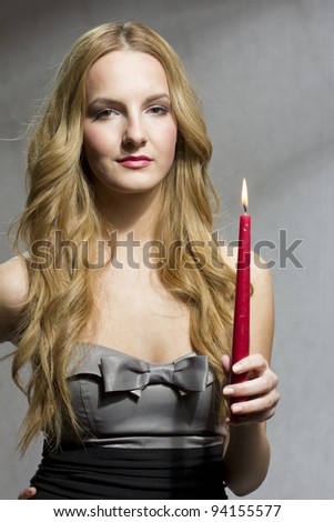 Young woman holding a candle at valentine\'s day