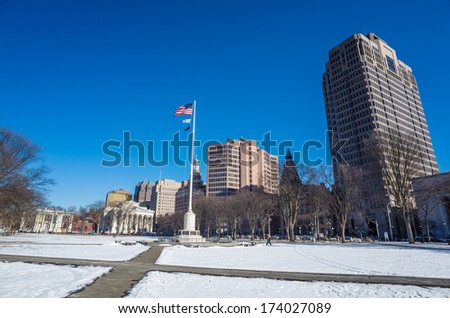 New Haven Green with snow and blue sky: a park in downtown New Haven, CT used for public events and bordered by Yale University.