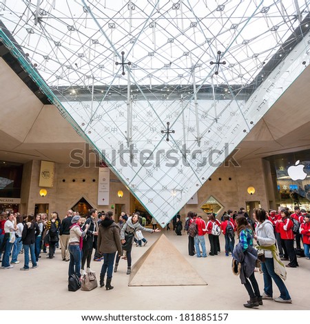 PARIS - JULY 20: People with Louvre Pyramid on July 20, 2012. it was designed by the architect I. M. Pei in 1984,