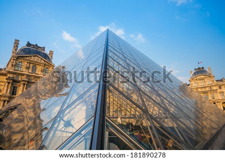 PARIS - JULY 22: Louvre pyramid on July 22, 2013 in Louvre Museum, Paris, France. With 8.5m annual visitors, Louvre is consistently the most visited museum worldwide.