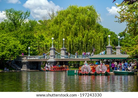 BOSTON, USA - MAY 20: Locals and tourists enjoying a ride on the famous swan boats at the Boston Public Garden in Boston, Massachusetts, USA on a sunny summer day of May 20, 2014.