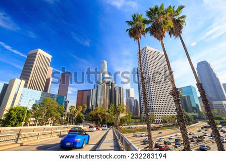 Downtown Los Angeles skyline during rush hour with blue sky