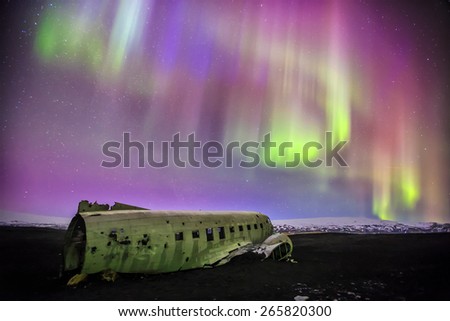 Northern lights over plane wreck on the  beach in Vik, Iceland