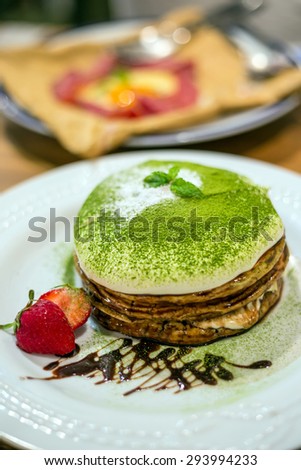 Crape cake pour with strawberry sauce on plate in Japan