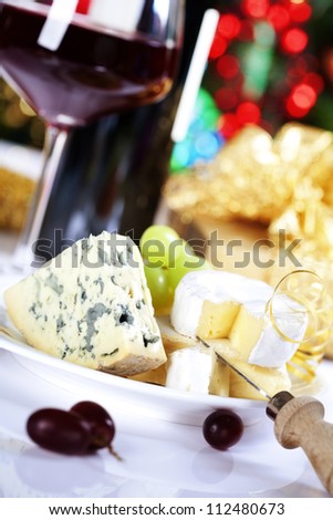 Cheese and wine on Christmass tree background