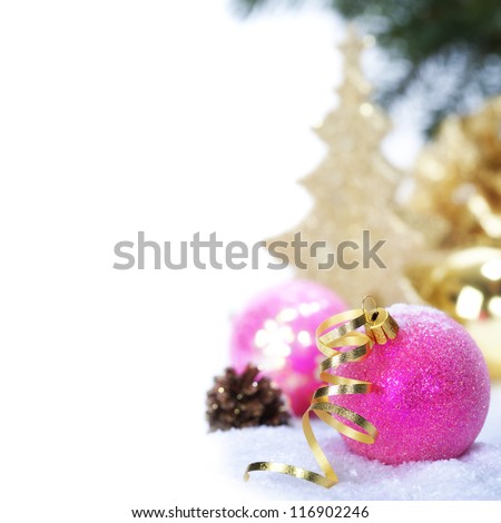 Pink christmas balls with decorations on a snow