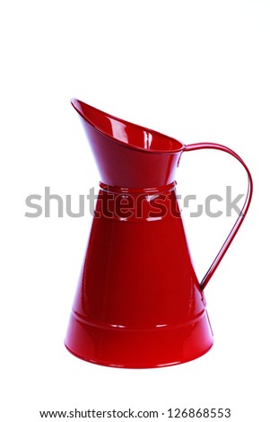 red metal pitcher over white