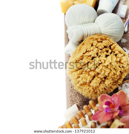 Spa and Wellness- bath brush, sponge, soap, towels and Herbal massage balls over white