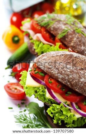Grain bread sandwiches with ham,cheese and fresh vegetables over white - healthy eating concept