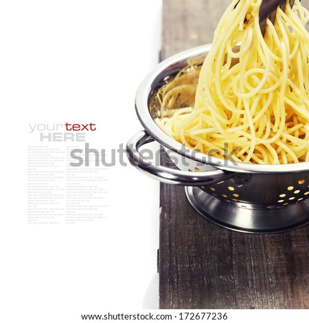 spaghetti in colander over white (with easy removable sample text)