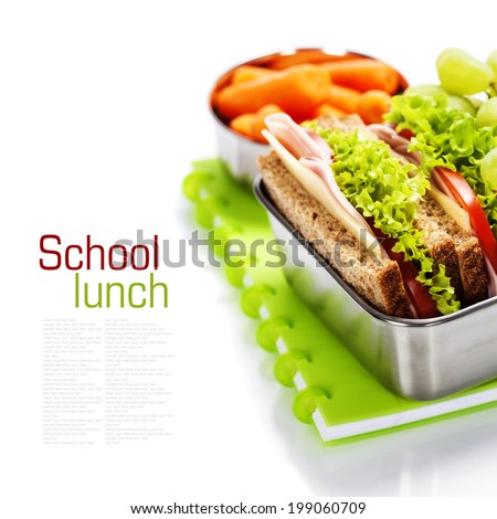 School lunch with a ham sandwich, apple, grapes and textbooks