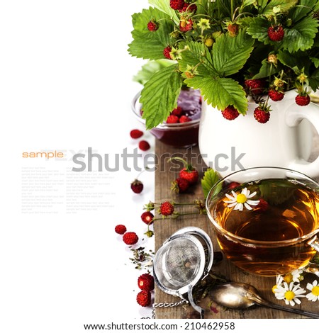 bouquet of wild strawberry with herbal tea and jam - bio food or health concept