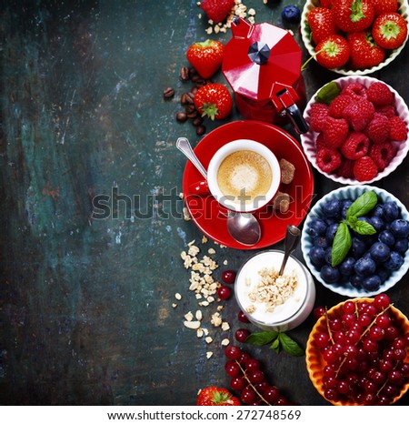 Healthy breakfast - yogurt with muesli and berries - health and diet concept. Blue background