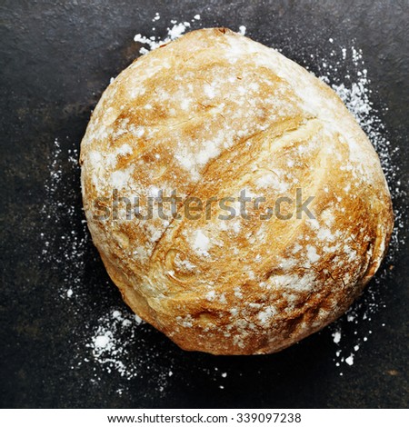Homemade bread loaf on rustic dark background
