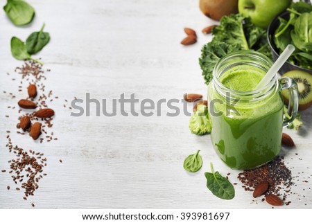 Healthy green smoothie and ingredients on white  - superfoods, detox, diet, health, vegetarian food concept