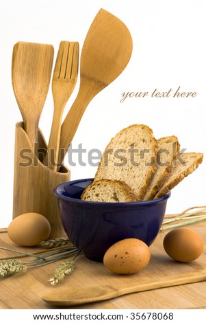 Bread eggs and cup of milk on a wooden board (With sample text)