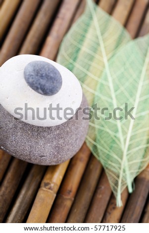stack of balanced zen stones and skeleton leaf
