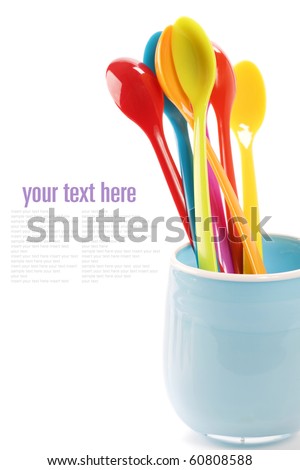 plastic spoons in a cup over white (with easy removable sample text)