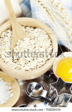 Fresh ingredients for oatmeal cookies (oat flakes, eggs, salt, flour)