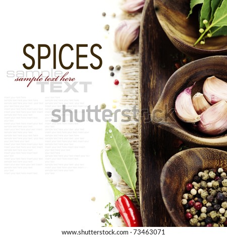 wooden bowls with fresh herbs and spices ( garlic, pepper, bay leaves) With sample text