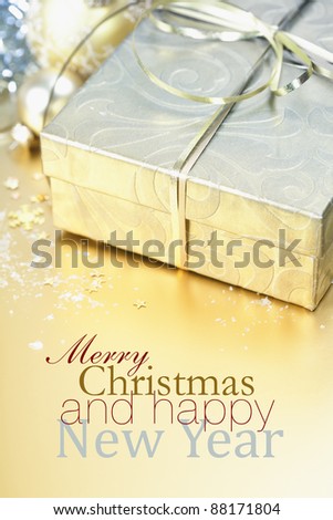 Golden gift box with golden ribbon and christmas decorations