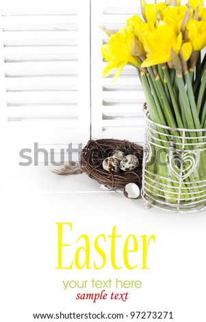 easter composition with eggs and spring flowers on white background (with sample text)