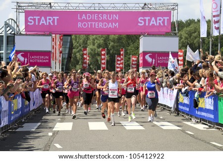 ROTTERDAM, THE NETHERLANDS - JUNE 10 2012: Runners sprint off the start line in the annual Ladiesrun 10 KM event held on Sunday June 10,  2012 in Rotterdam.