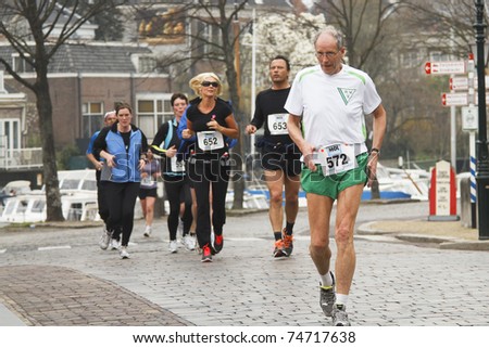 DORDRECHT, THE NETHERLANDS - APRIL 3: runners in \'Dwars door Dort\' 10km race for all ages, in Dordrecht, The Netherlands on April 3, 2011