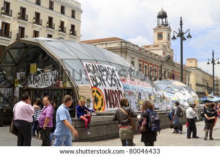 MADRID, SPAIN - JUNE 6: Protest posters pasted on the window of the metro station on Puerta del Sol Square June 6, 2011 in Madrid. These protests are known as the Spanish Revolution days in Madrid.