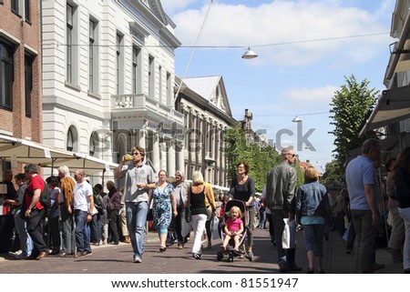 DORDRECHT, NETHERLANDS - JULY 3: Visitors at book market on the Steegoversloot Sunday July 3, 2011 in Dordrecht. 16th Dordtse book market with 300 booksellers and 600 stalls has yearly 75000 visitors