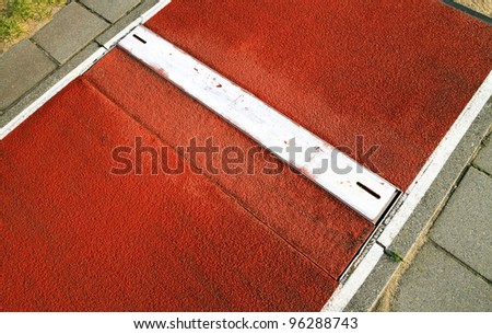 Long jump spring plank in a sports and Athletics stadium close up