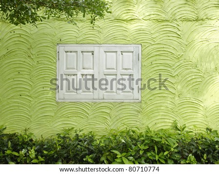 The white window on the wave pattern wall.