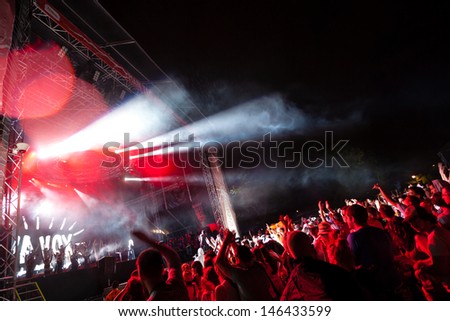 NOVI SAD, SERBIA - JULY 10: Audience and rain infront of the Main Stage at EXIT 2013 Music Festival, during Viva Vox\'s performance on July 10, 2013 in the Petrovaradin Fortress in Novi Sad.