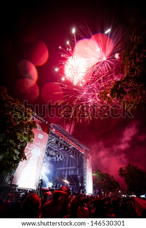 NOVI SAD, SERBIA - JULY 10: Rain and fireworks above the Main Stage at EXIT 2013 Music Festival, during the official opening of the festival on July 10, 2013 in the Petrovaradin Fortress in Novi Sad.