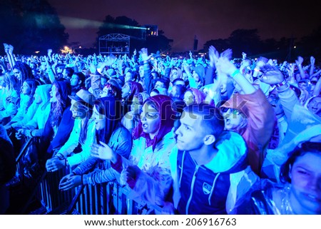 NOVI SAD, SERBIA - JULY 11: Audience infront of the Main Stage at EXIT 2014, during RUDIMENTAL\'s performance on July 11, 2014 in the Petrovaradin Fortress in Novi Sad. (motion blurs and brightly lit)