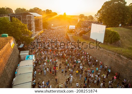 NOVI SAD, SERBIA - JULY 12: Audience infront of the Dance Arena on sunrise, at EXIT 2014 Music Festival, on July 12, 2014 in the Petrovaradin Fortress in Novi Sad.
