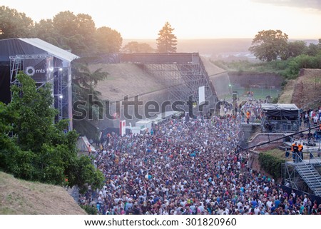 NOVI SAD, SERBIA - JULY 11 2015: Audience infront of the Dance Arena at EXIT 2015 Music Festival, during sunrise, on July 11, 2015 at the Petrovaradin Fortress in Novi Sad, Serbia.