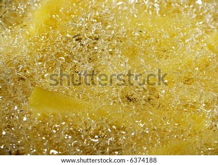 baking french fries - chips in oil, close up photo