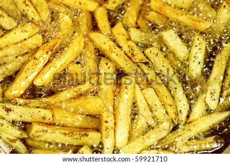 french fries - baking potatoes in hot oil