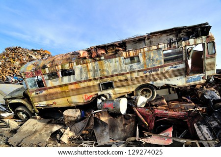 Wrecked bus in a junkyard