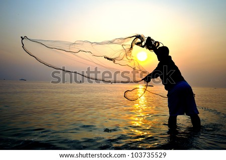 throwing fishing net during sunrise, Thailand - Stock Image