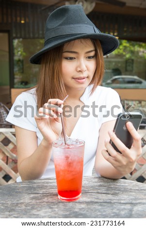Portrait of young woman drinking strawberry italian soda