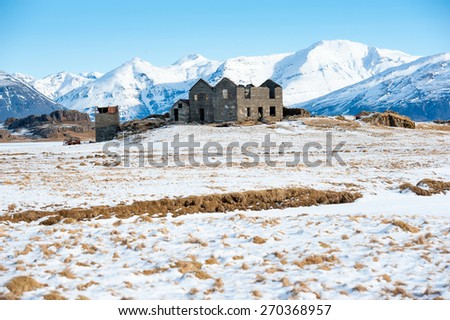 Old farm on a hill in a wintry landscape , Iceland