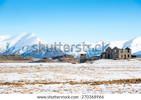 Old farm on a hill in a wintry landscape , Iceland