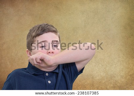 Child Covering his Mouth with his Arm to Stifle Sneeze or Yawn
