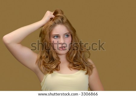 Puzzled young woman pulling on her hair