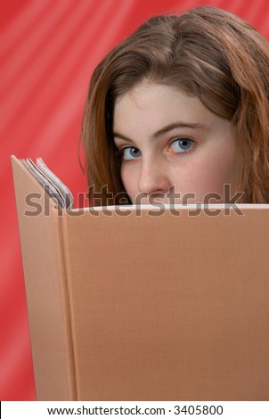 Female gazing from her book, which is blank for copy space