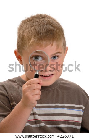 Boy with magnifying glass to his eye making eye bigger